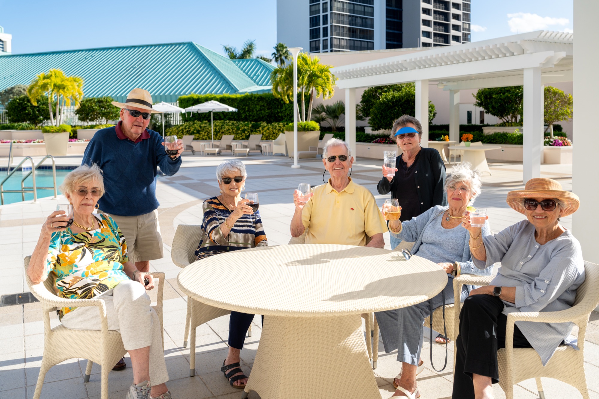 Residents enjoying happy hour near the pool at The Glenview