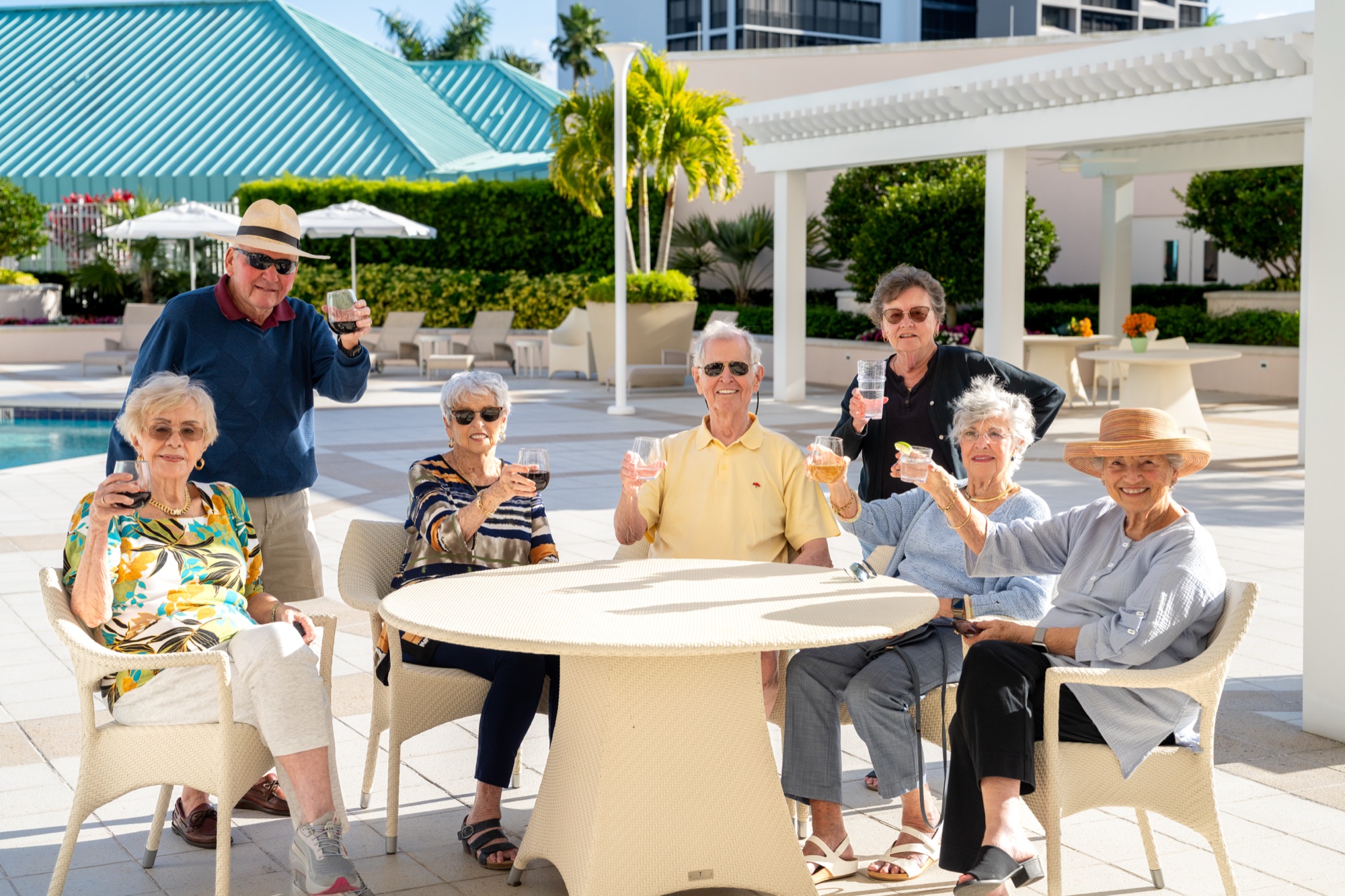 Residents enjoying happy hour near the pool at The Glenview